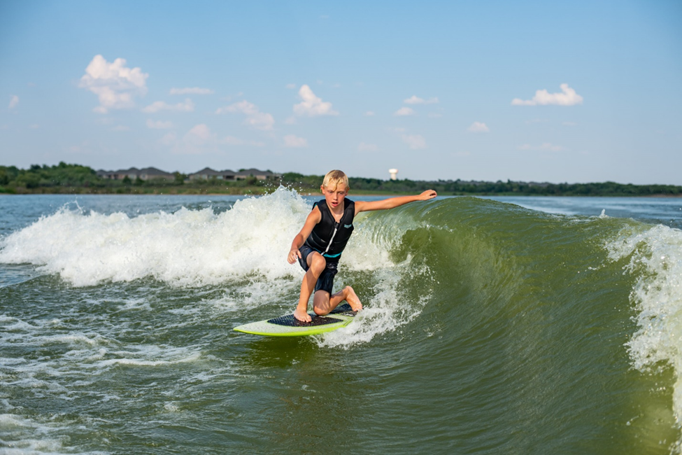 Kid surfing on Lake Lewisville. 