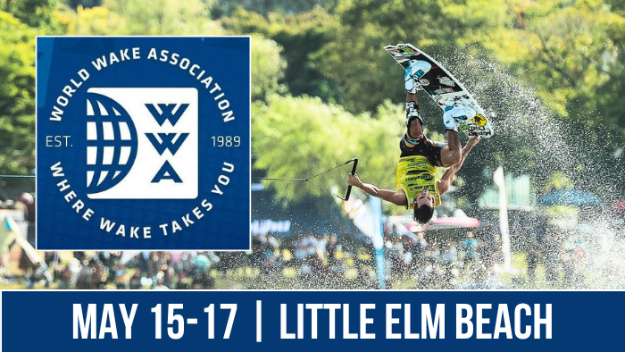 A person performs an aerial wakeboarding trick on a sunny day, near an event sign for the World Wake Association. The sign features the WWA logo and the text "Where Wake Takes You." The event dates are May 16-17 at Little Elm Beach.