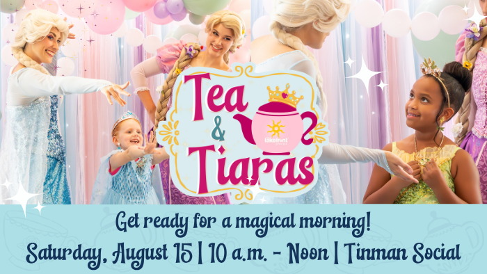 A group of performers dressed in fairy tale costumes is interacting with children. They are gathered around a sign that reads "Tea & Tiaras" with a teacup illustration. The background features pastel-colored balloons. Text at the bottom reads, "Get ready for a magical morning! Saturday, August 15 | 10 a.m. - Noon | Tinman Social.