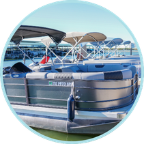 RESERVE (1) A docked pontoon boat with a covered canopy, moored at a marina.