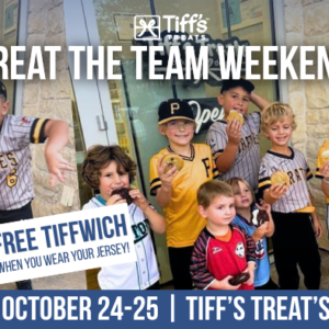 A group of smiling children wearing baseball uniforms stand holding cookies in front of a Tiff's Treats store. The image promotes "Treat the Team Weekend" with an offer for a free Tiffwich for those wearing a jersey. Dates mentioned are October 24-25 at Tiff's Treats Little Elm. A Tiffwich image is also shown.